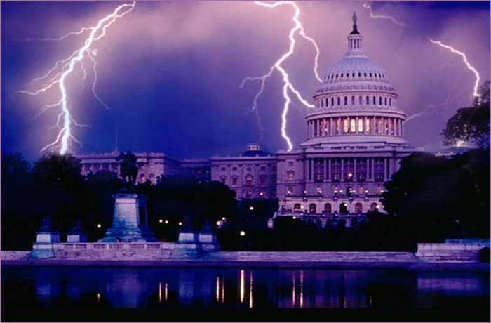 The U.S. Capitol building illuminated by lightning during a storm, with a purple sky and reflections in the water.