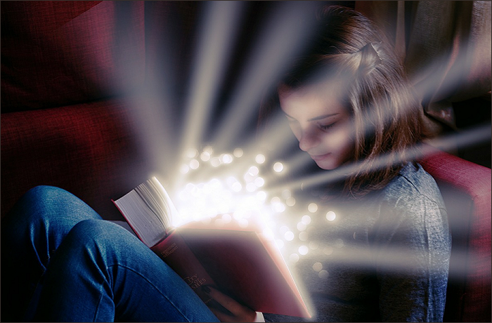 A young woman sitting on a couch, reading a book that emits glowing lights and magical sparkles.